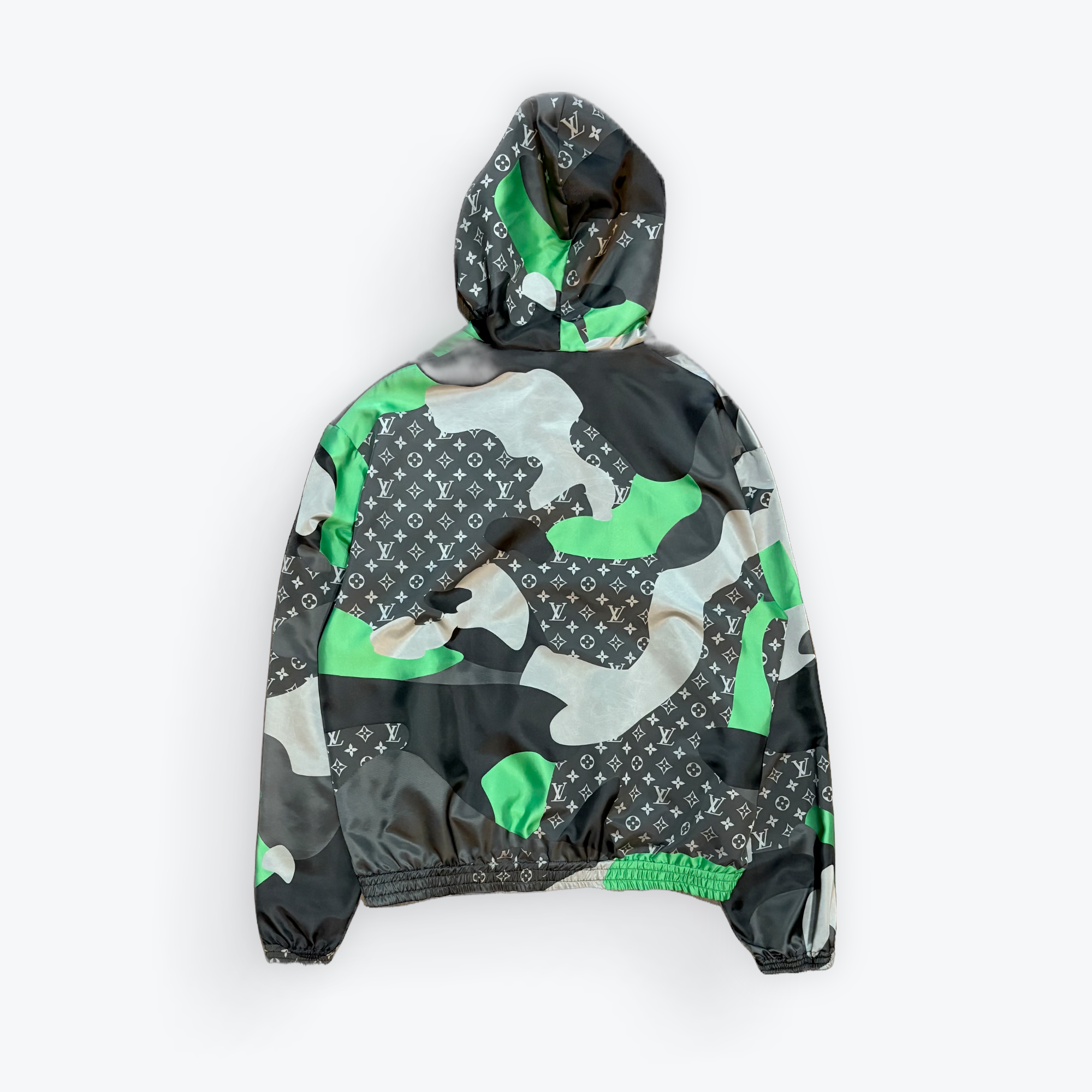 Camouflage-patterned jacket with green accents on a white background